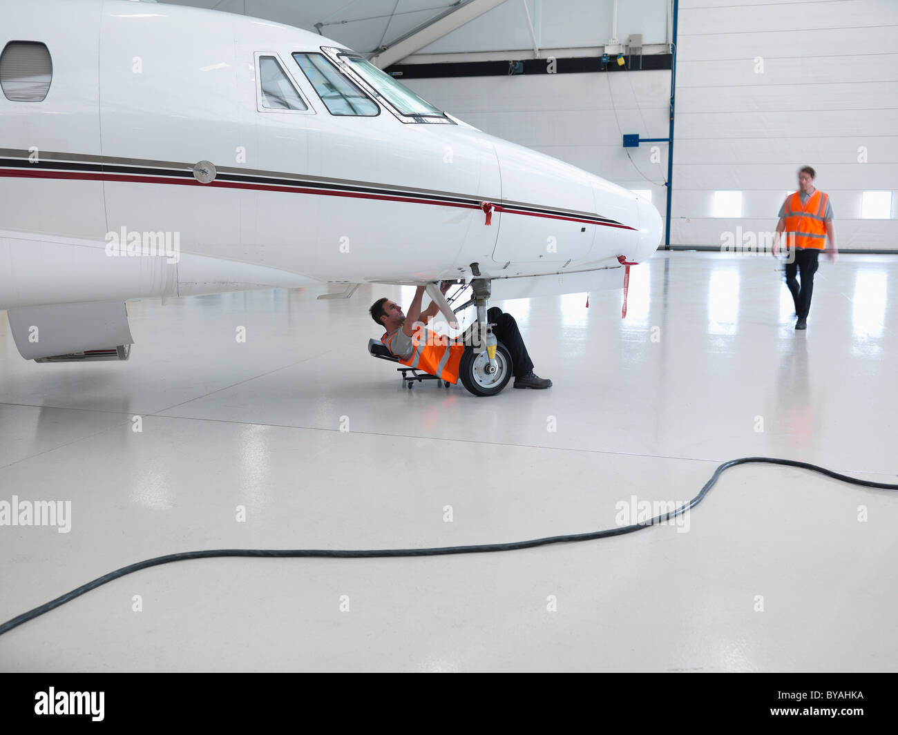 Engineers working on jet aircraft Stock Photo
