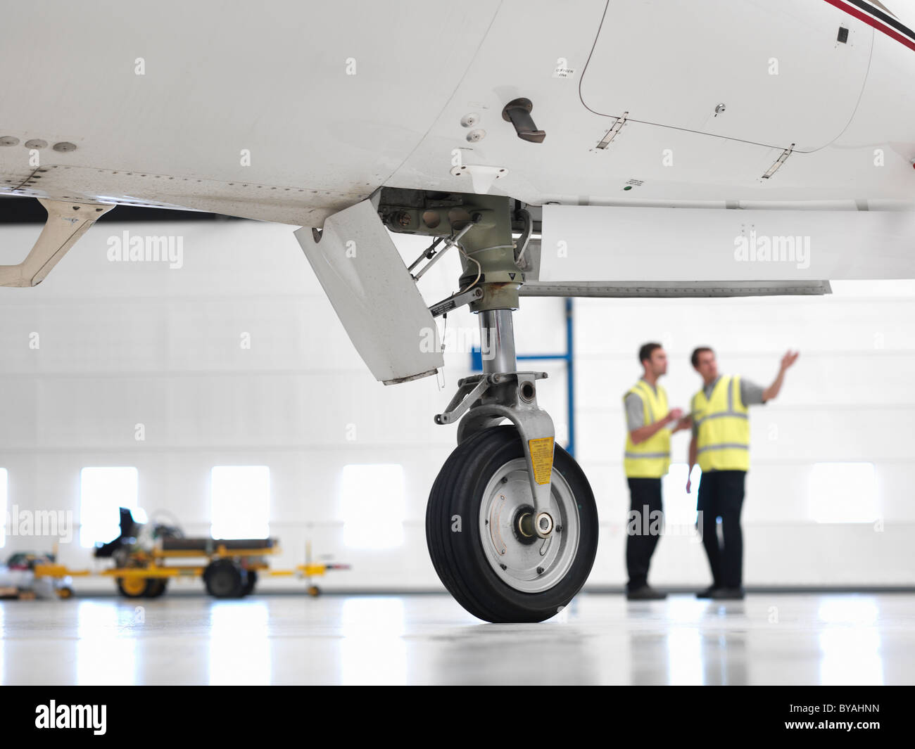Engineers with jet aircraft wheel Stock Photo