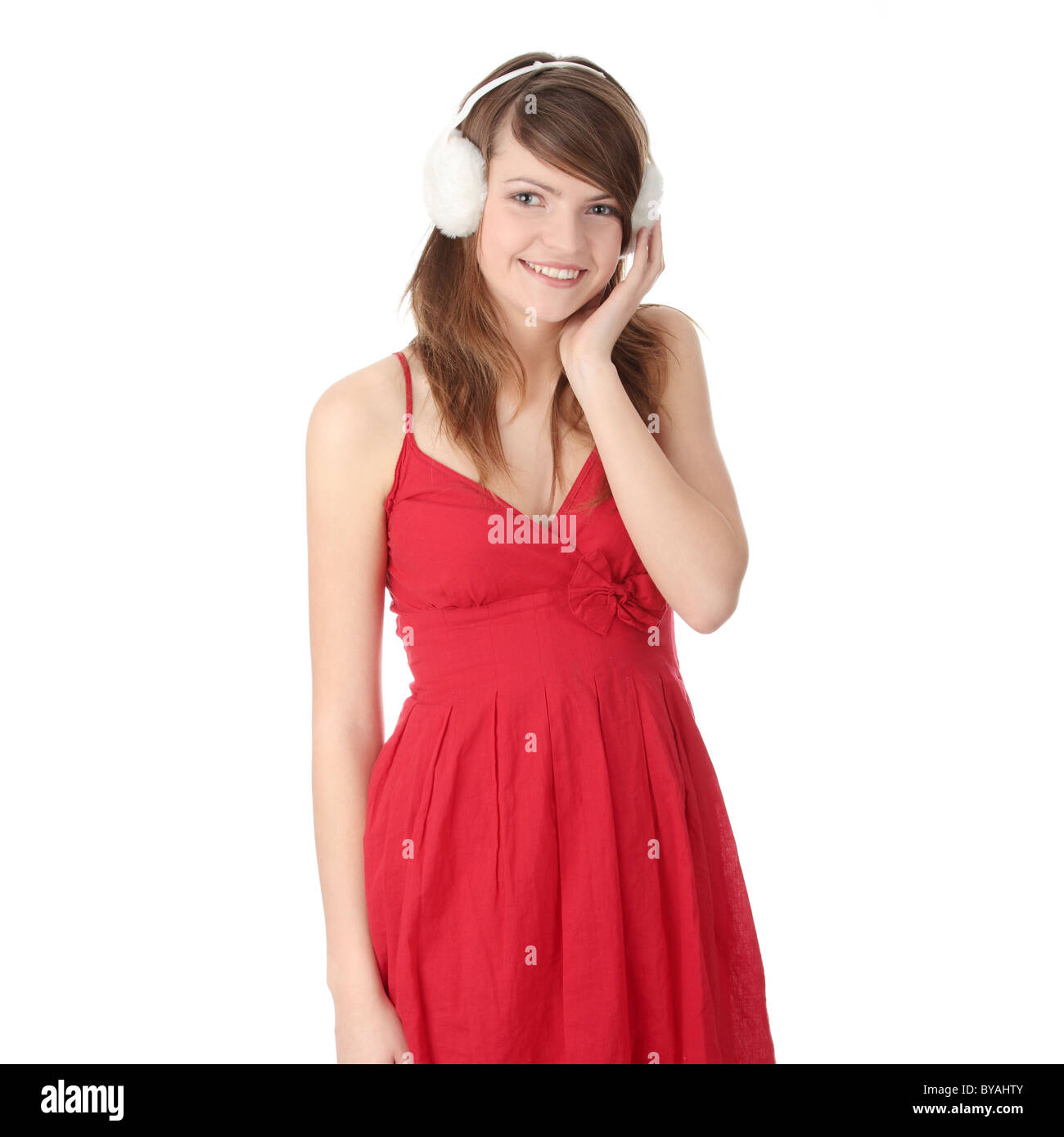 Pretty young teen girl wearing red dress and white earmuff, isolated on  white Stock Photo - Alamy