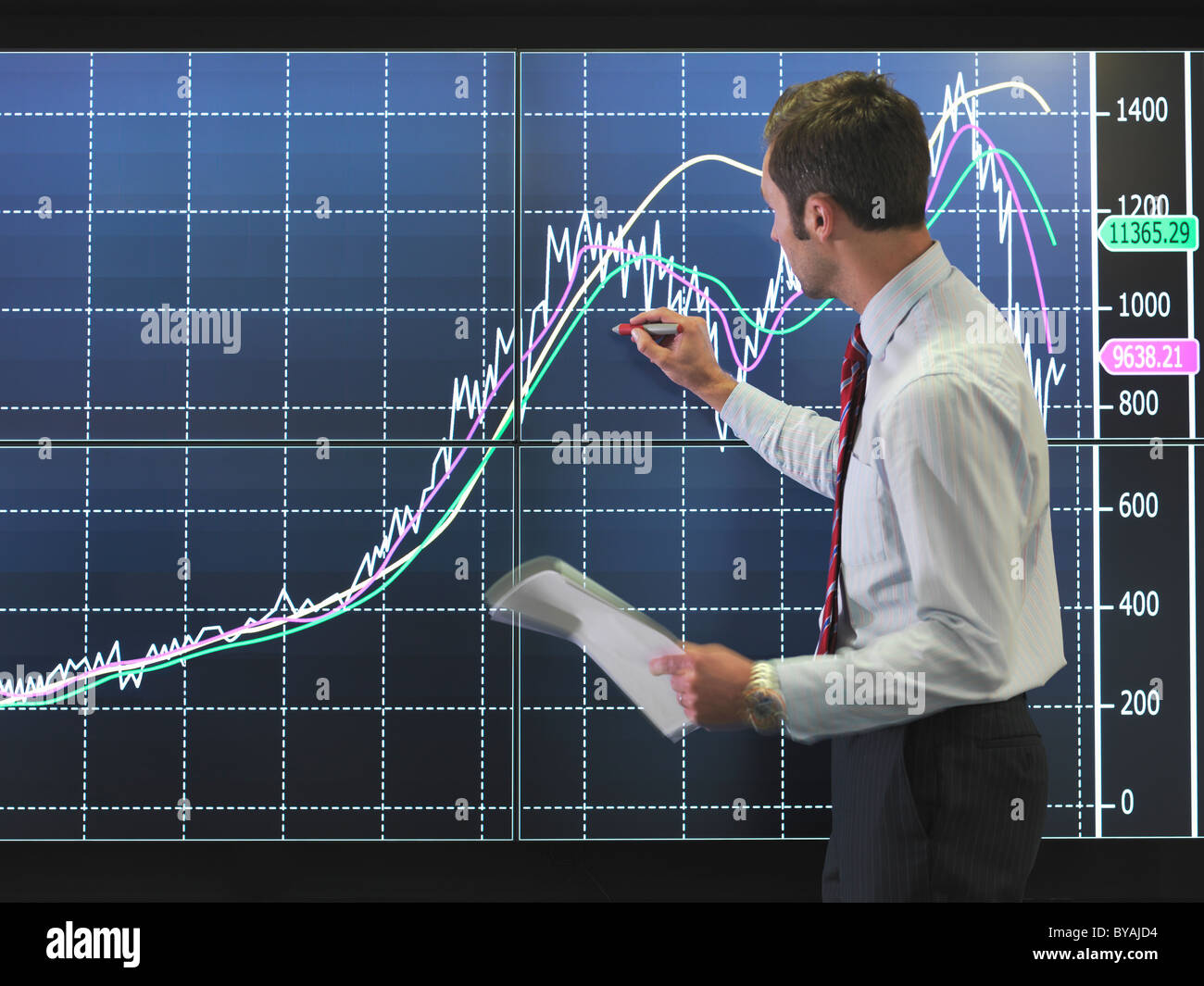 Businessman with graph on screen Stock Photo