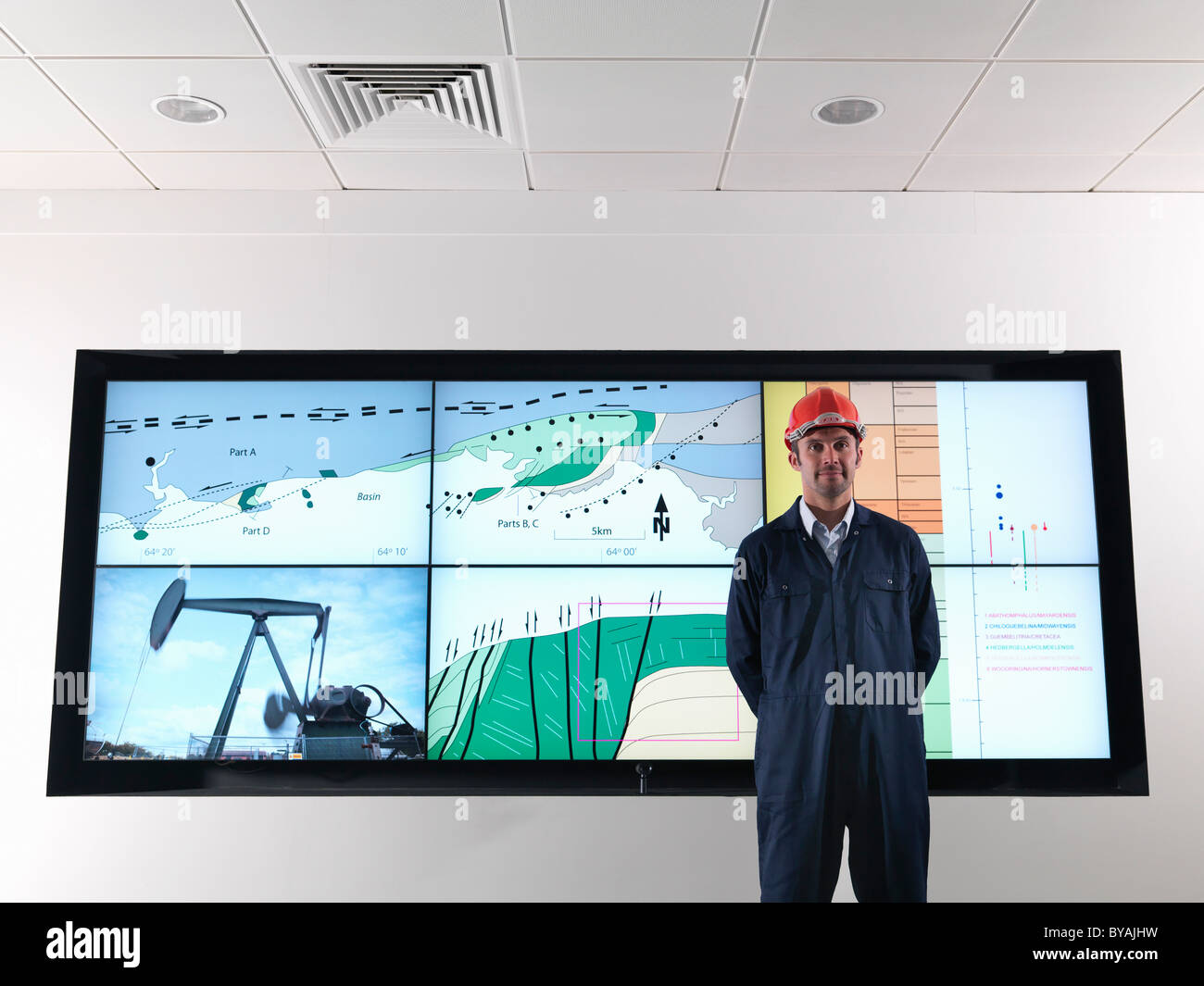 Oil worker with geology screen Stock Photo