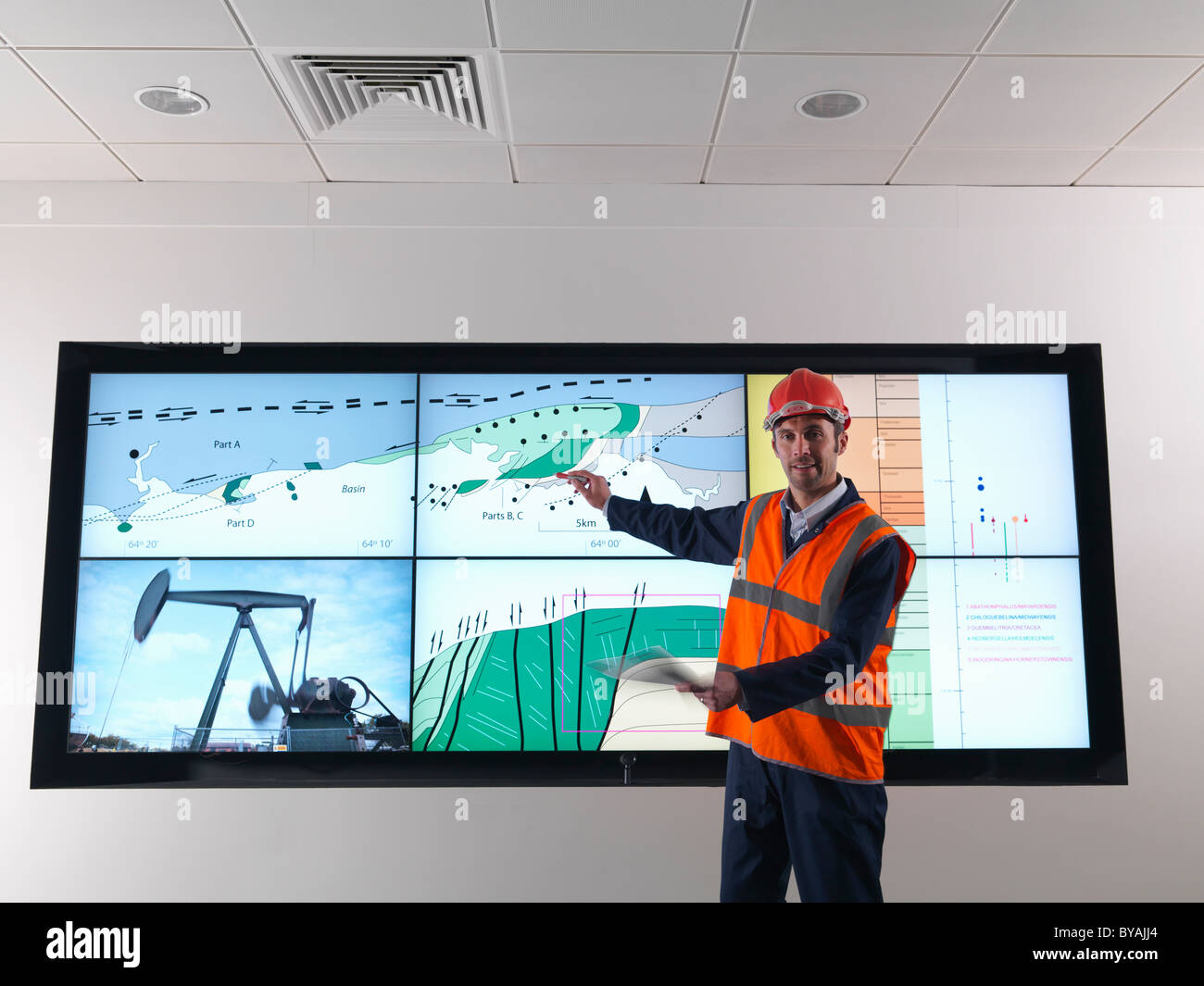 Oil worker with geology screen Stock Photo