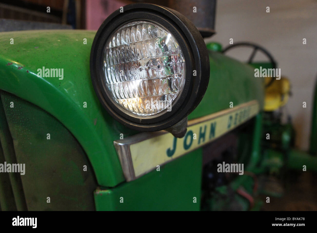 Looking in the eye of a 1960s era John Deere 1010 Tractor Stock Photo