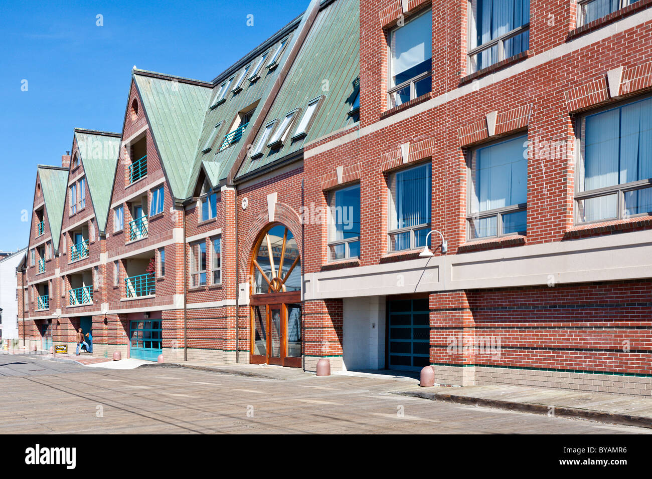 Old warehouses are converted to upscale condominiums on the wharf in the Old Port district of Portland, Maine Stock Photo