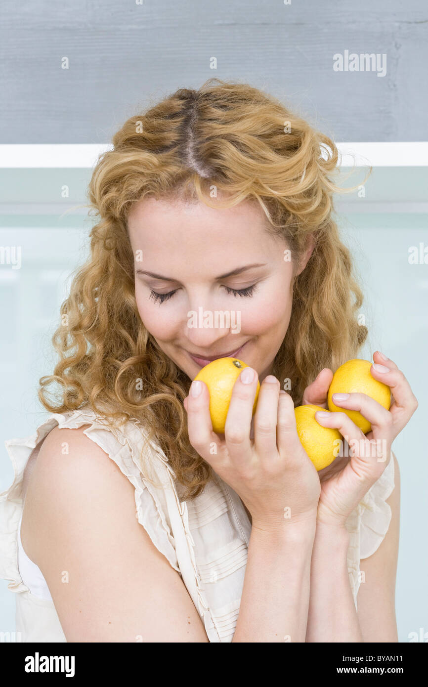 Woman smelling lemons Stock Photo Alamy