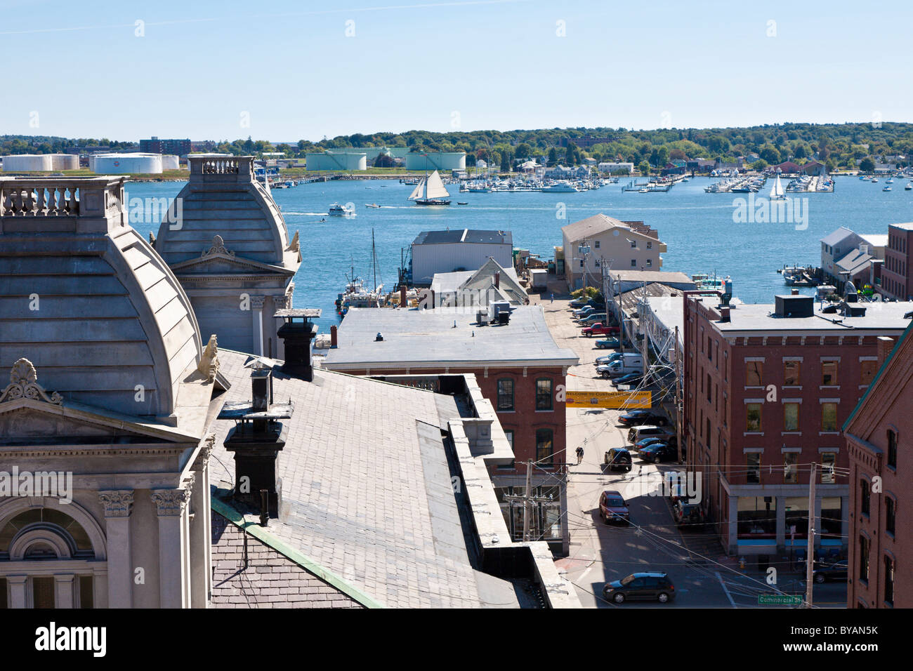 Sailboats pass by the US Custom House and the Custom House Wharf on Casco Bay in Portland, Maine Stock Photo