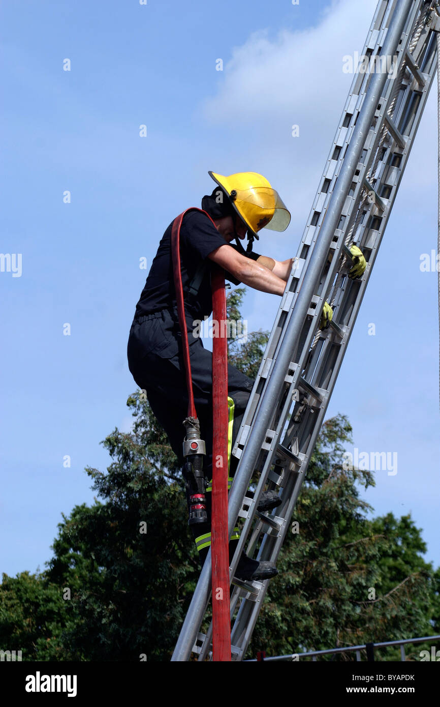 Fireman climbing a ladder hires stock photography and images Alamy