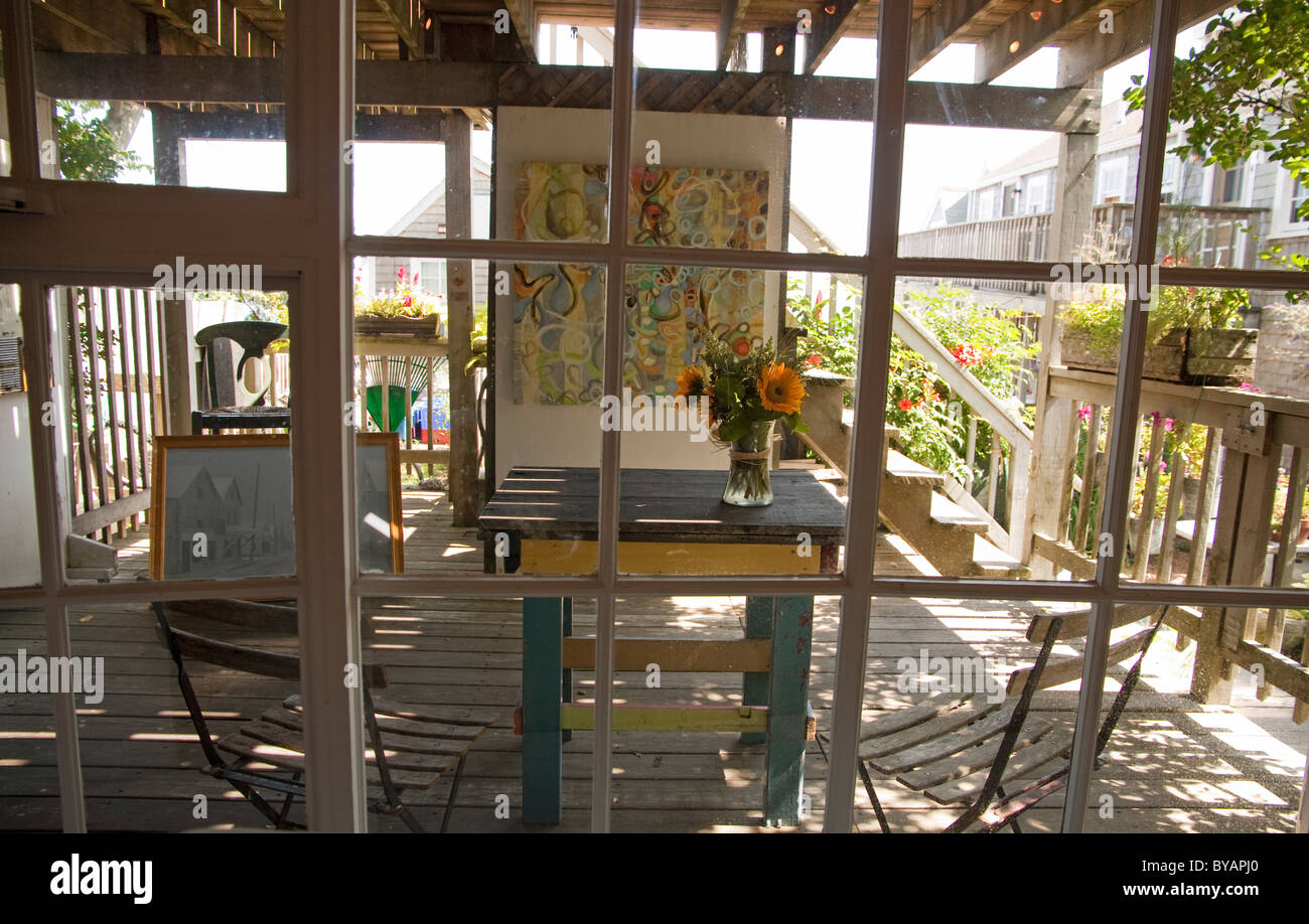 Art studio with paintings on display through window panes. Stock Photo