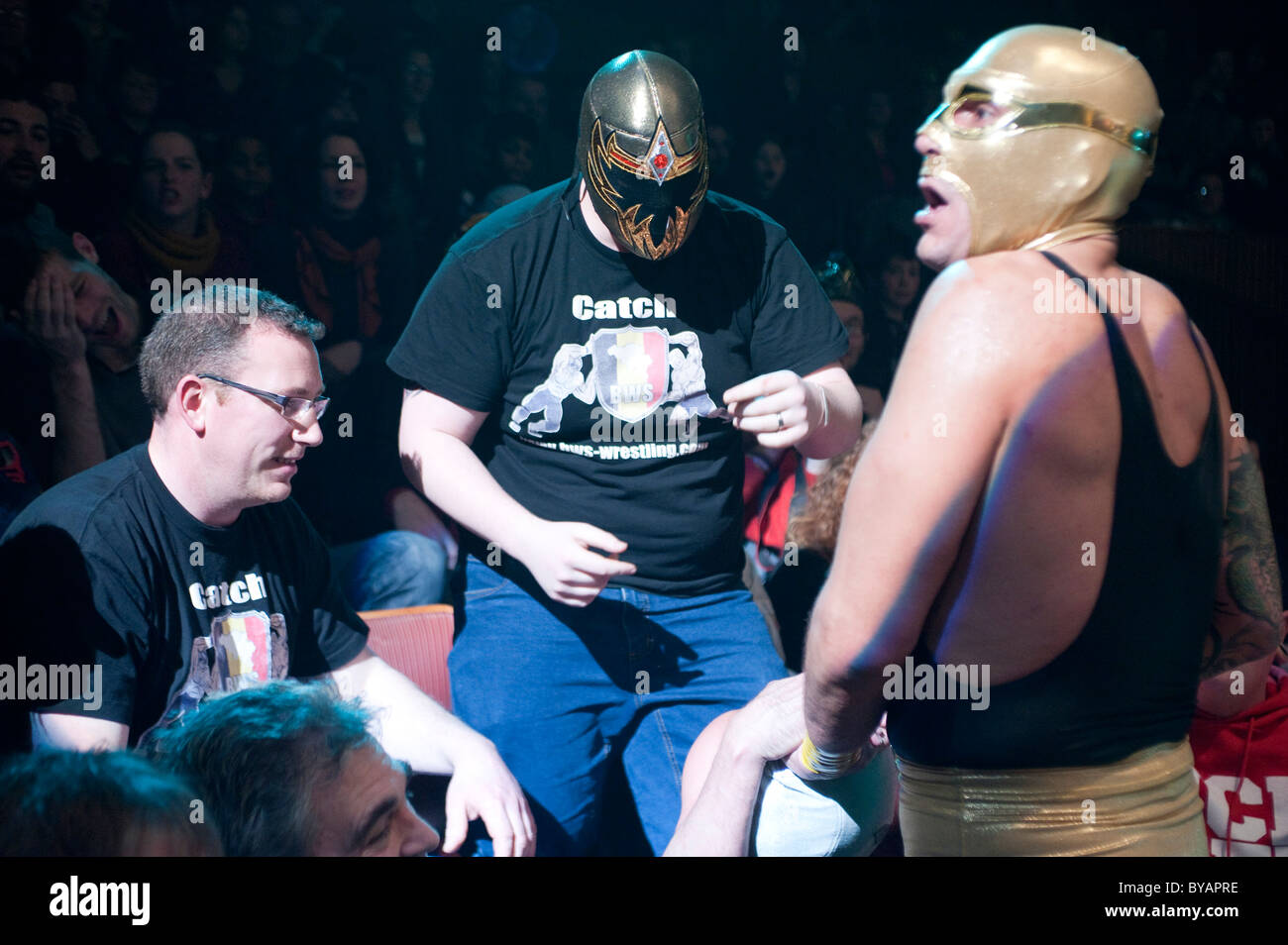 Wrestling fan  arguing with a Mexican wrestler during an exhibition in Brussel's' Cirque Royal'. Stock Photo