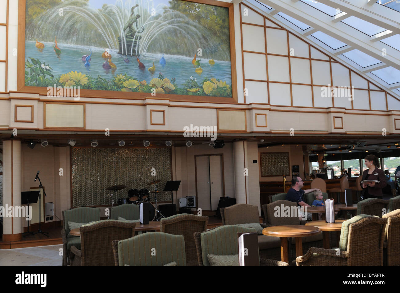 The Garden Room on Cunard's ship, 'Queen Elizabeth,' is tranquil during the day and lively at night when a band performs. Stock Photo