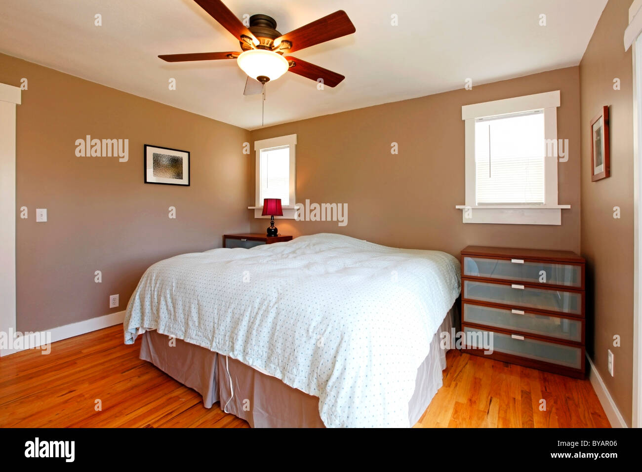 Beige brown bedroom interior with blue bedding Stock Photo Alamy
