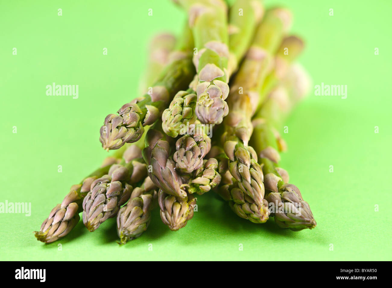 Eat your greens - fresh organic green asparagus tips and stems, raw cookery ingredient Stock Photo