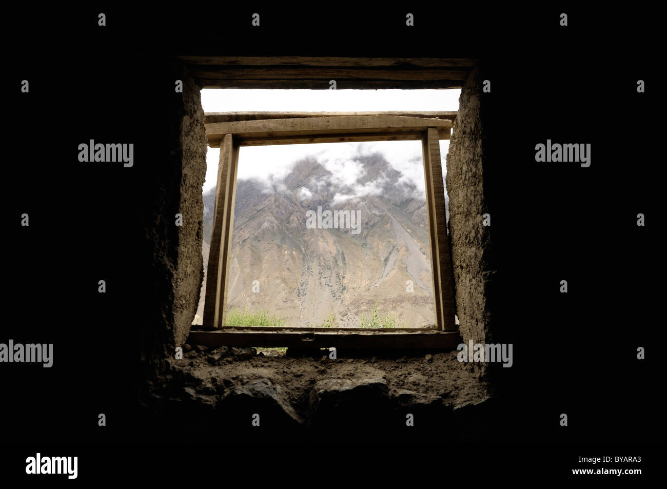 A view of the mountains in Spiti Valley from inside an abandoned mud hut, India. Stock Photo