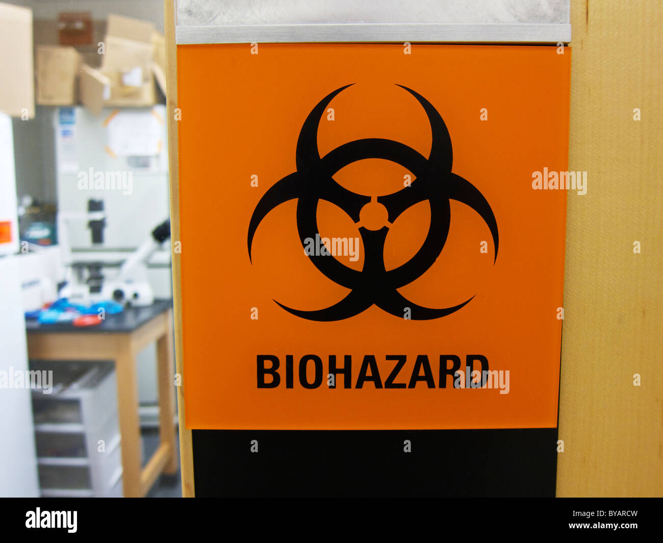 Biohazard warning sign on laboratory door. Stock Photo
