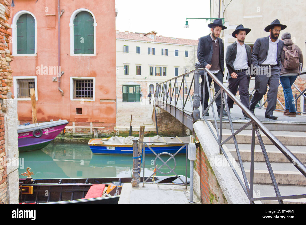 Jewish Ghetto, Ghetto Nuovo ('New Ghetto'). Men of Jewish faith crossing bridge across canal. Stock Photo