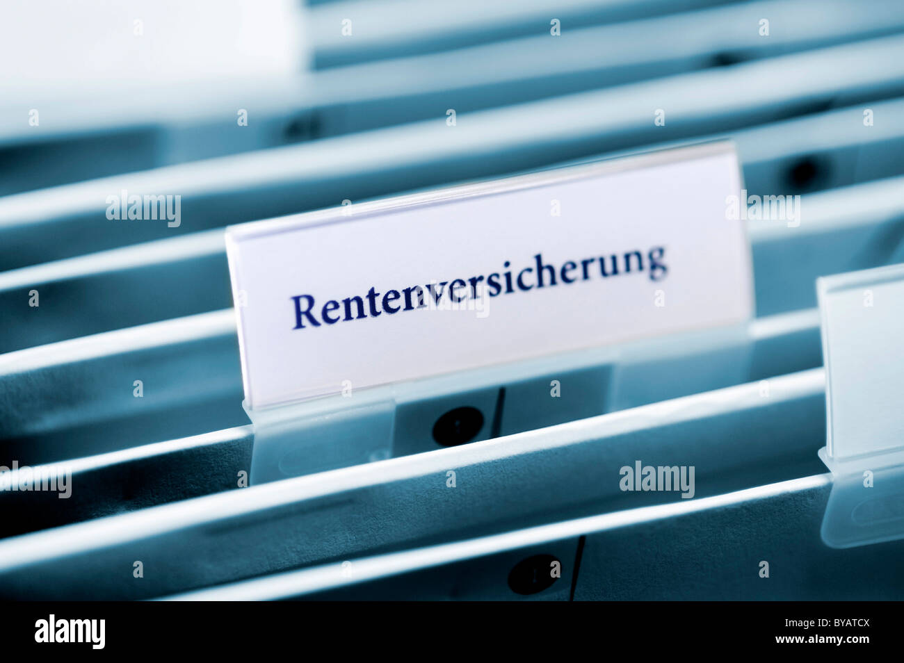Rider on a hanging folder labeled Rentenversicherung or pension Stock Photo