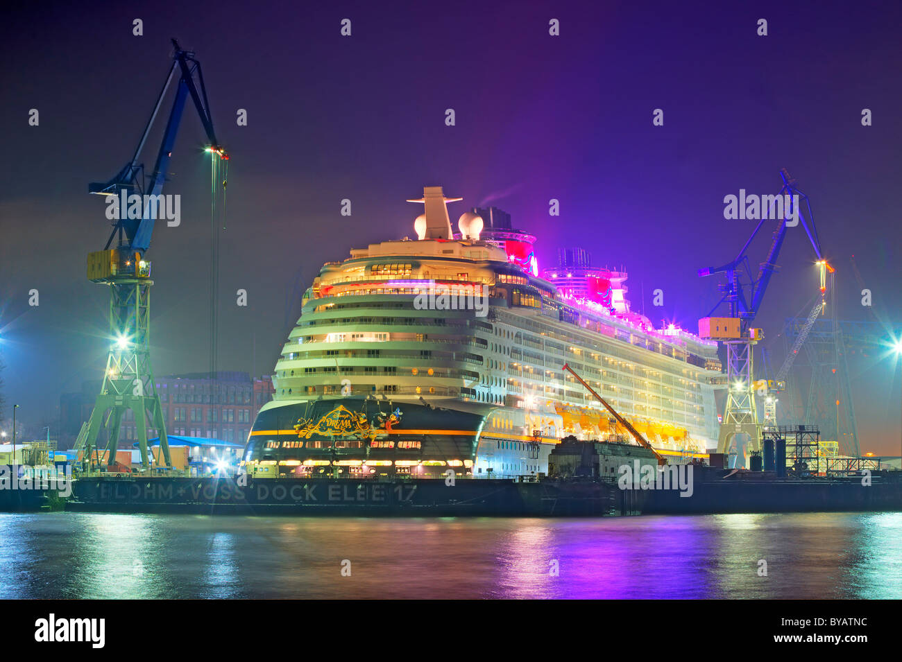 Ship, cruiser, big cruise liner 'Disney Dream' in dock 17 in Hamburg harbour at river Elbe at night, Blohm and Voss shipyard in Stock Photo