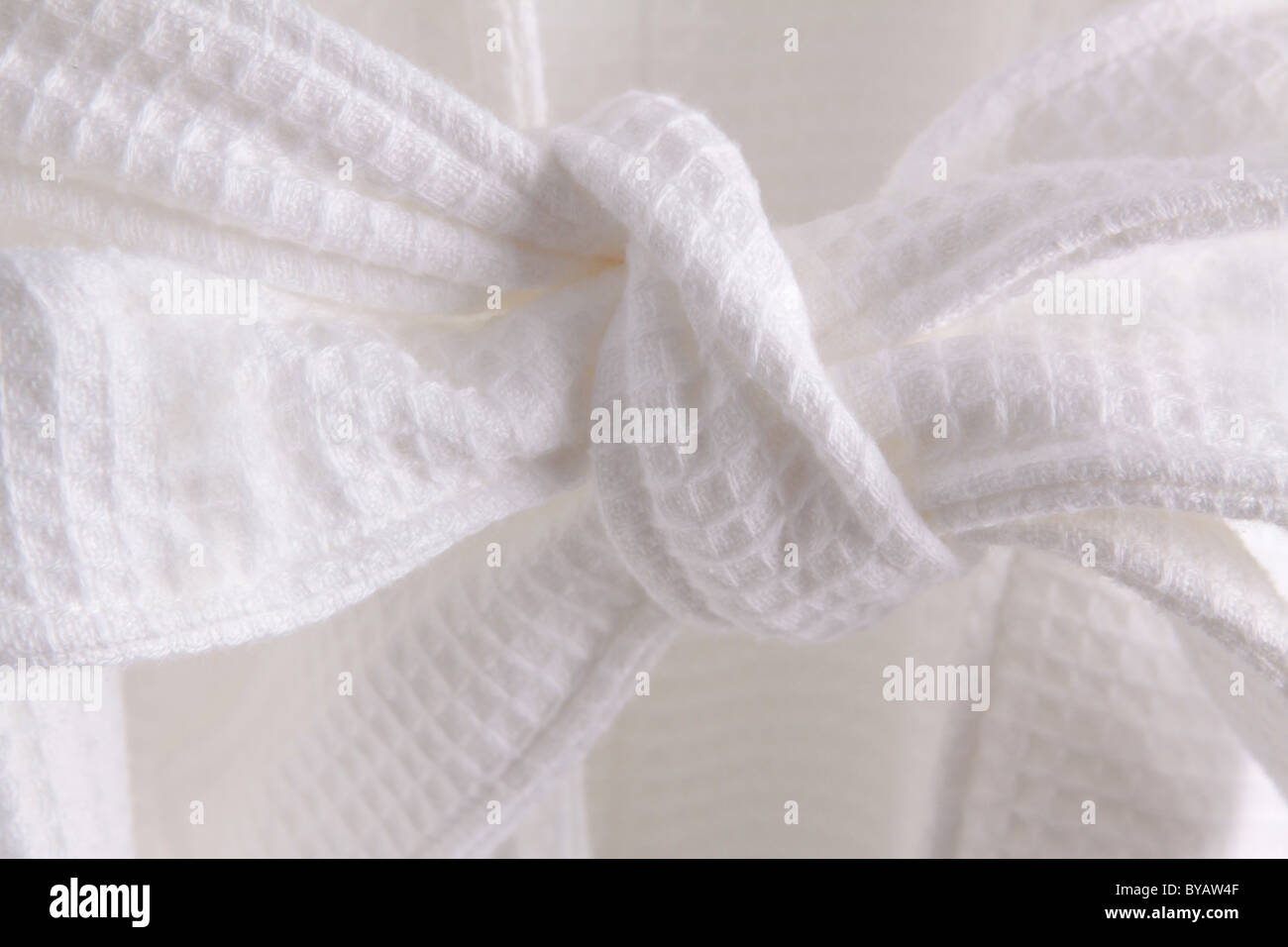 White dressing gown belt tied in a knot detail giving a feeling of luxuaty relaxation illustration or concept Stock Photo