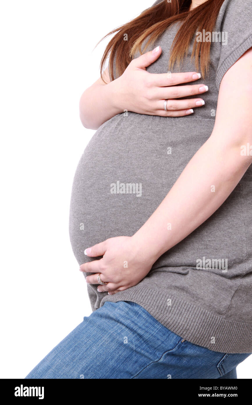 Pregnant mother holds her stomach of tummy in a caring protective manor Stock Photo
