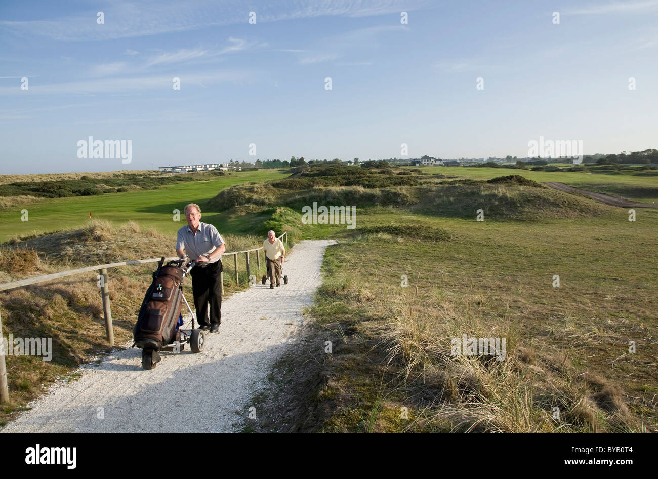 Golfers and caddies working together on the course