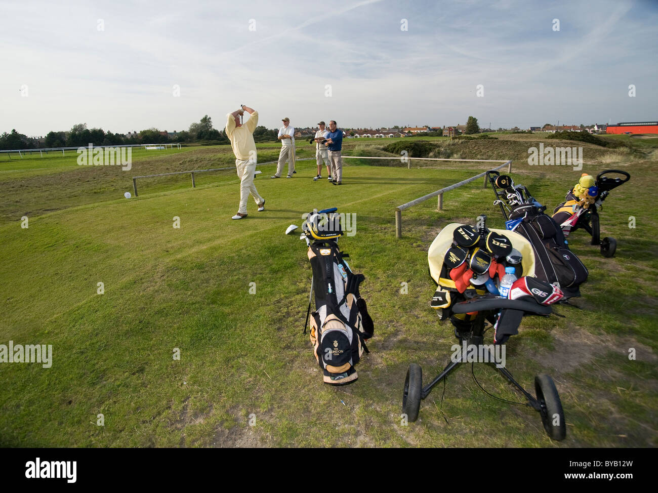 Golfers and their caddies on Caister golf course Stock Photo Alamy