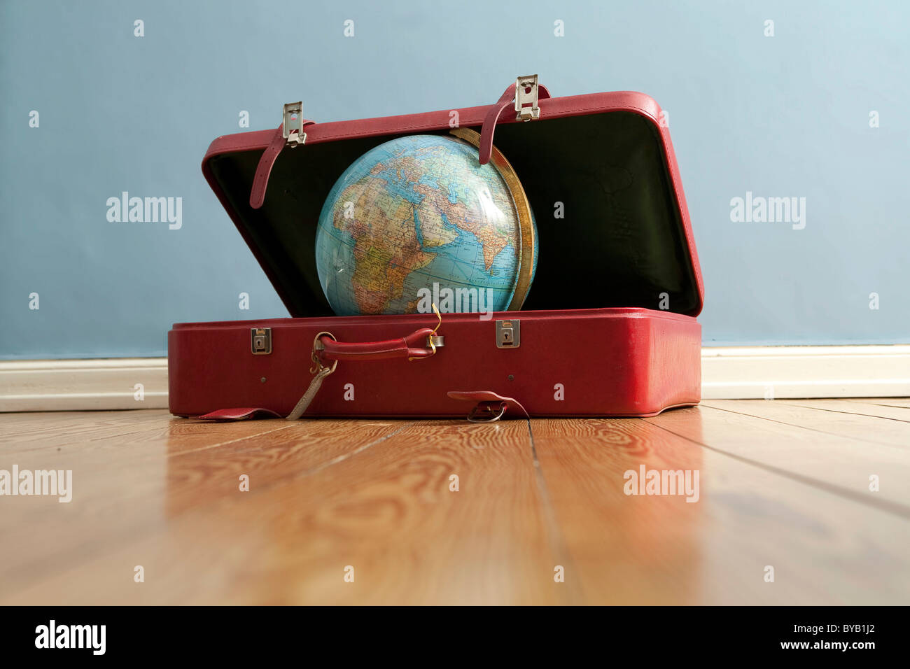 Globe in a suitcase, symbolic image for traveling, vacation, world trip Stock Photo