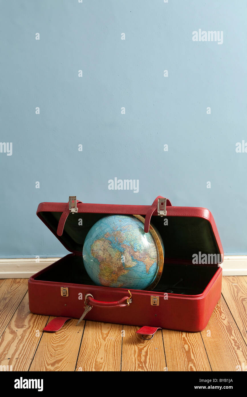 Globe in a suitcase, symbolic image for traveling, vacation, world trip Stock Photo