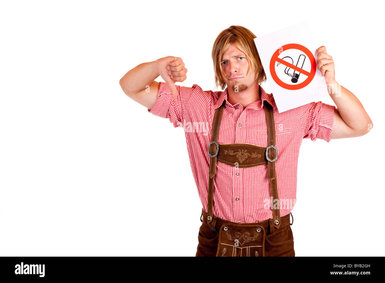 Bavarian man in lederhose disagrees to non-smoking-rule. Isolated on white background. Stock Photo