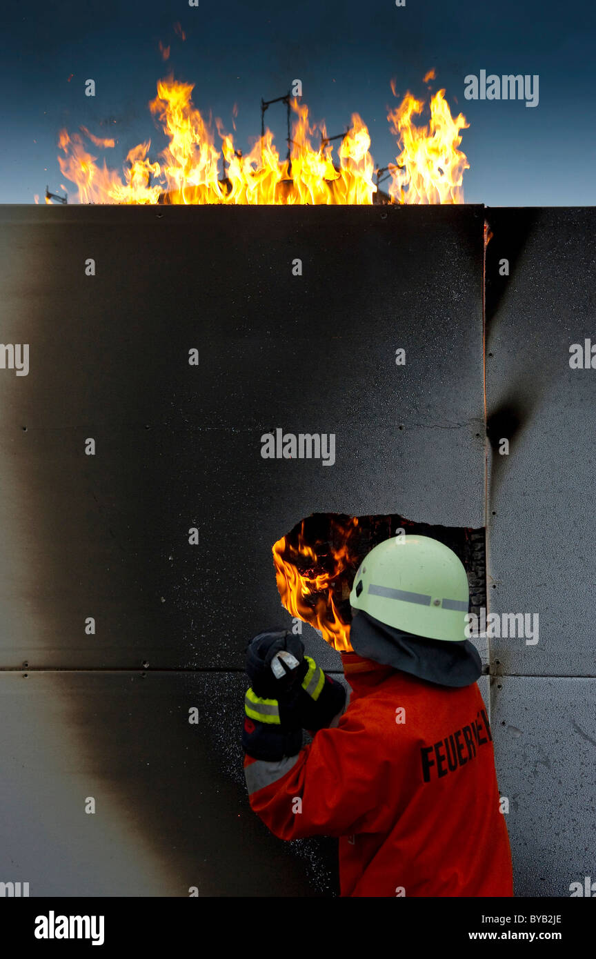 Firefighter extinguishing a fire Stock Photo