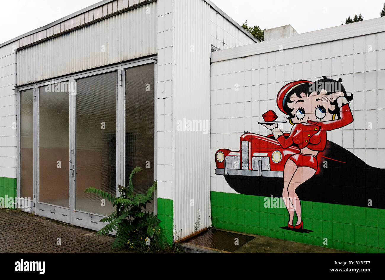 Abandoned car repair shop with a drive-in restaurant, advertising character painted on the wall, Krefeld, North Rhine-Westphalia Stock Photo