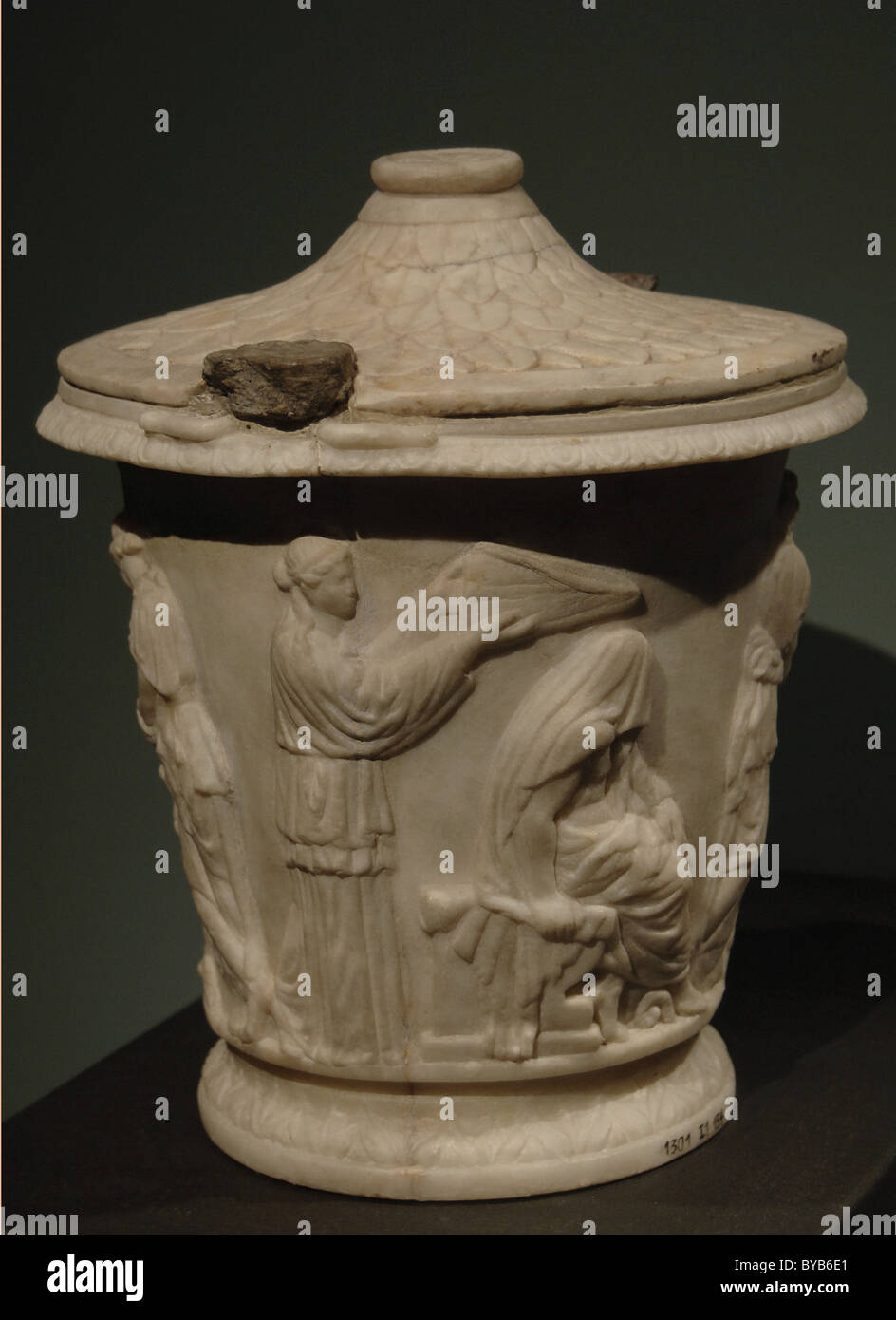 Cinerary urn with reliefs depicting Heracles (Hercules) beginning in the Eleusinian Mysteries. White marble. Stock Photo