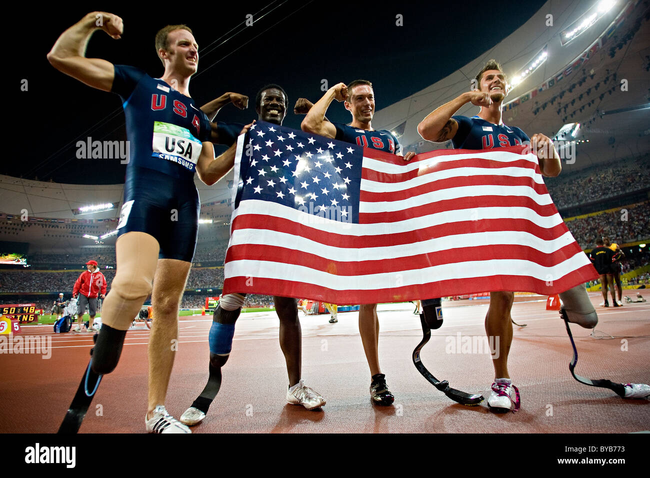 USA team members celebrate after their victory in the men's T44 4x100m final relay race at the Beijing 2008 Paralympic Games; Stock Photo