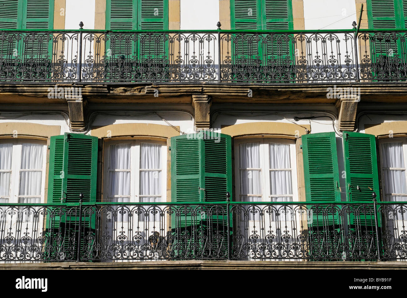 Windows, green shutters and balconies, fishing quarter, Hondarribia, coastal village, Irun, Pais Vasco, Basque Country, Spain Stock Photo