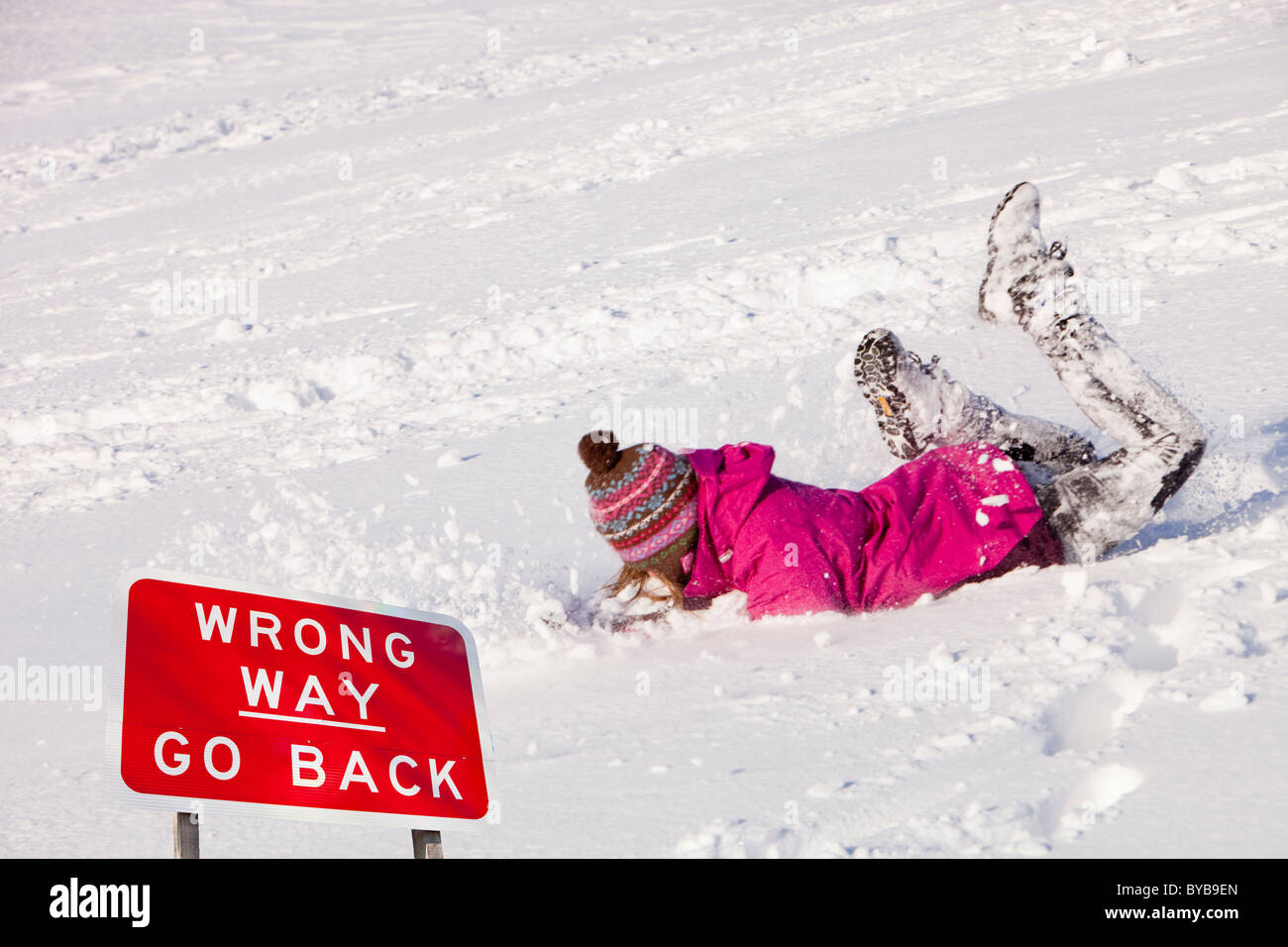 A young girl tripping up in the snow, Settle, Yorkshire Dales, UK. Stock Photo