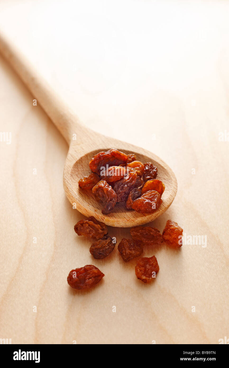 wooden spoon with raisins Stock Photo