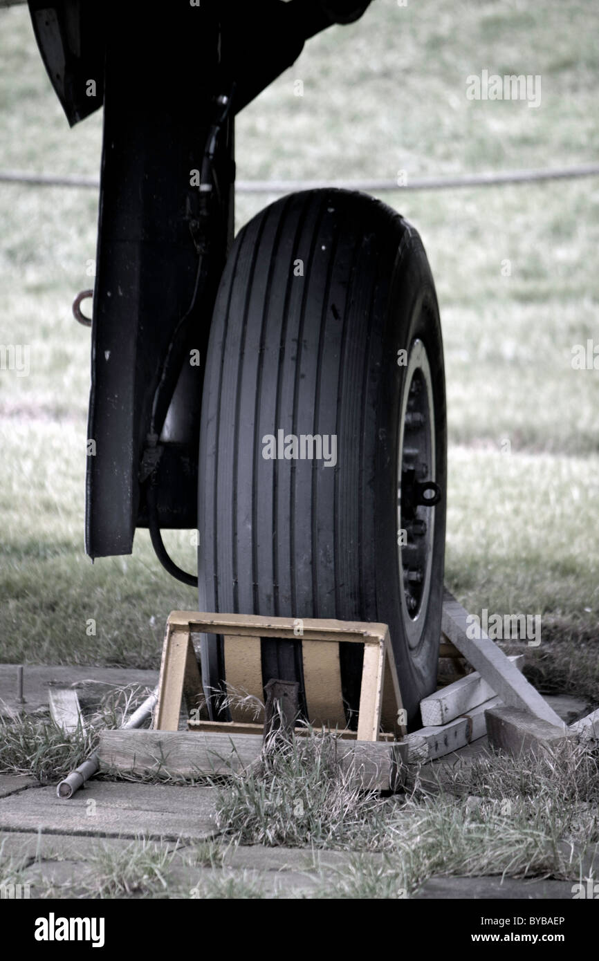 A landing wheel with chocks by the airplane Stock Photo Alamy