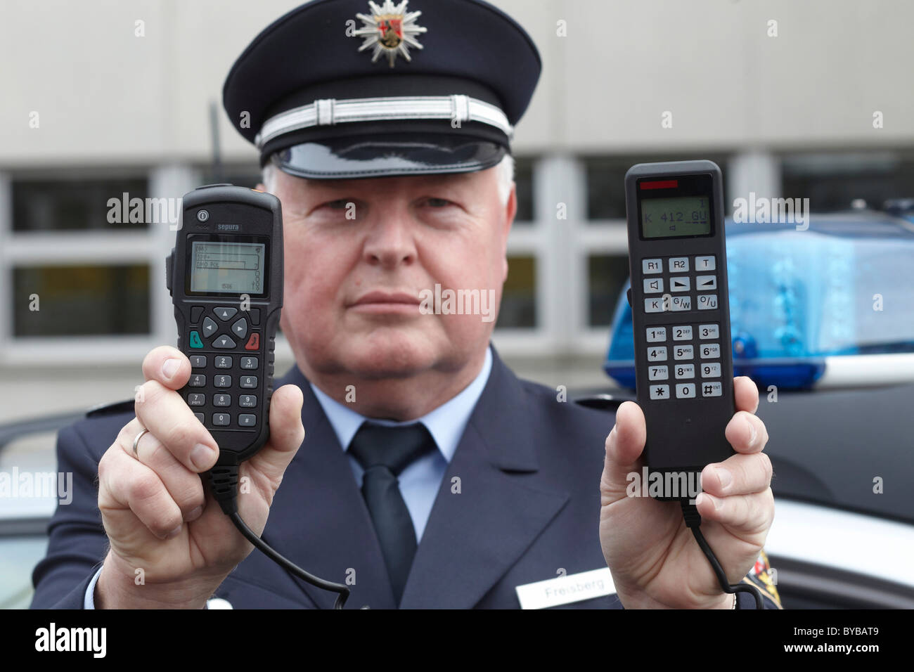 Police officer displaying a new digital radio which is currently being tested by the Rhineland-Palatinate police, left Stock Photo
