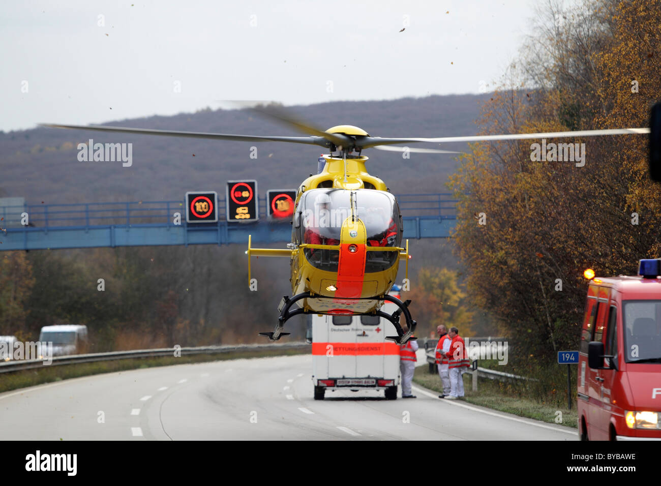 An ADAC EC 135 rescue helicopter taking-off at an accident site on the A61 motorway near Niederzissen, Rhineland-Palatinate Stock Photo