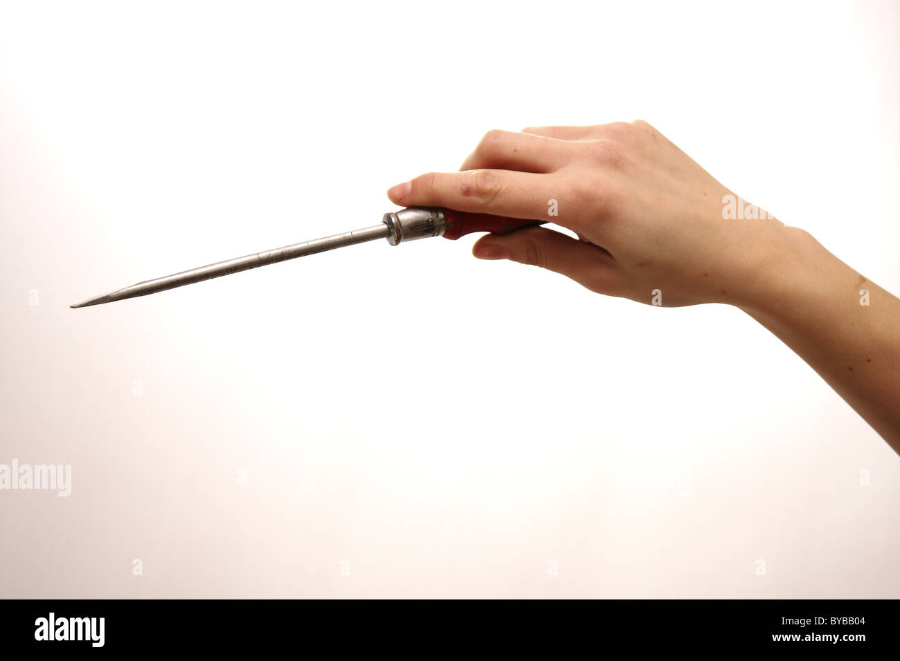 A white Caucasian female holding a pozi screwdriver on a white background also as a cut out Stock Photo