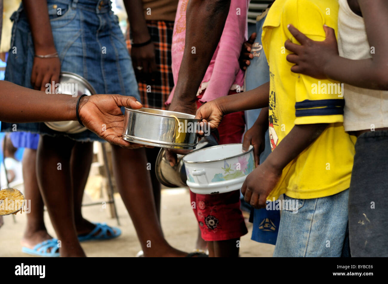 Food distribution to needy children at a camp for victims of the January 2010 earthquake, Croix-des-Bouquets district, , Haiti Stock Photo