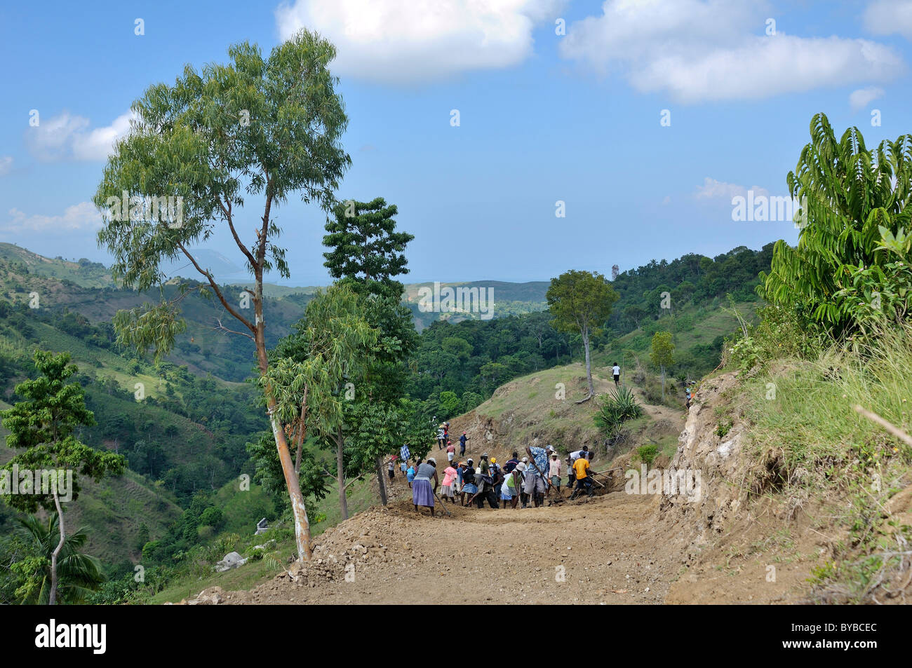 Inhabitants of a mountain village building a road with the assistance ...