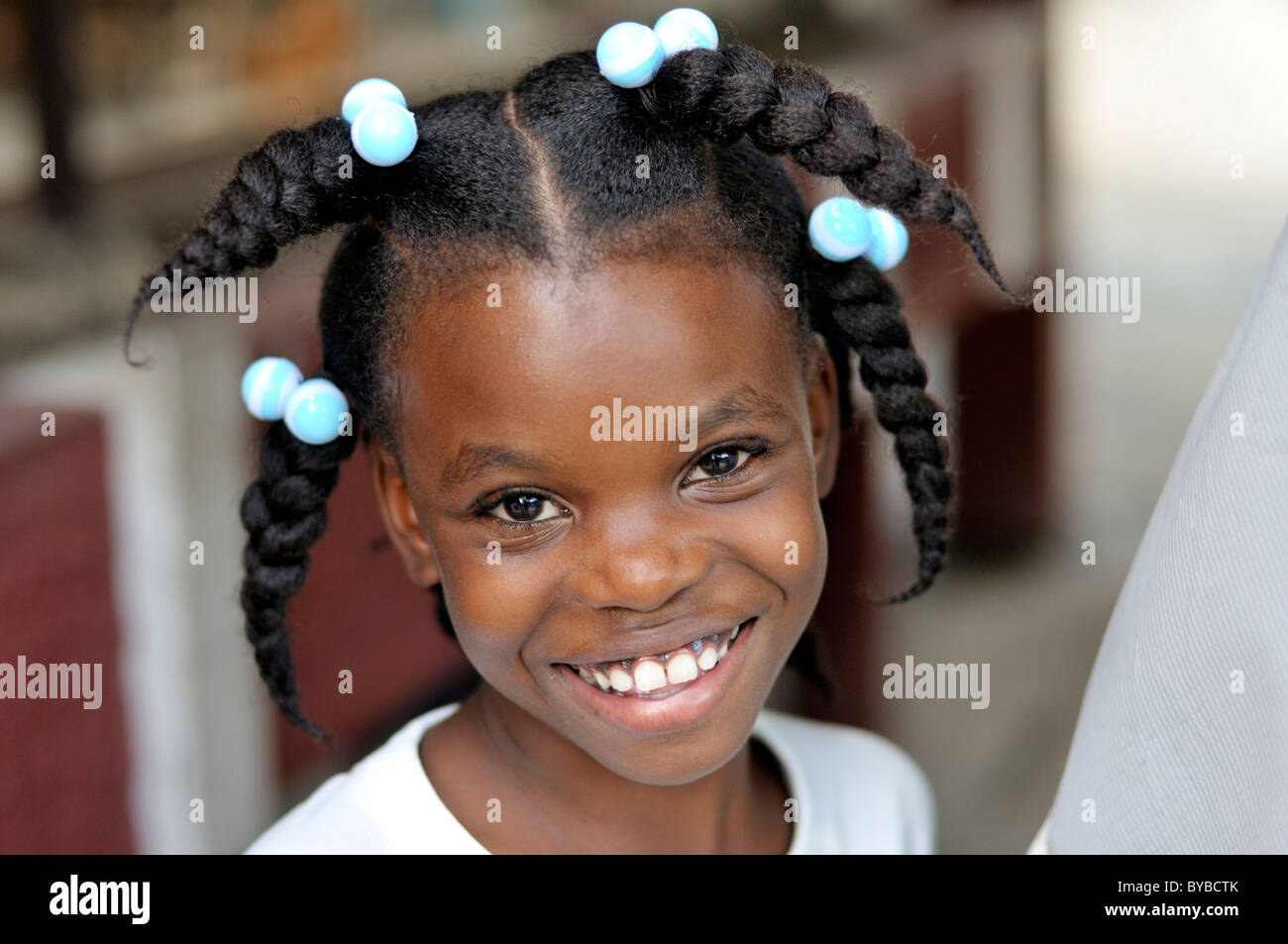Portrait of a smiling girl with funny hairstyle, Delmas 89 district,  Port-au-Prince, Haiti, Caribbean, Central America Stock Photo - Alamy