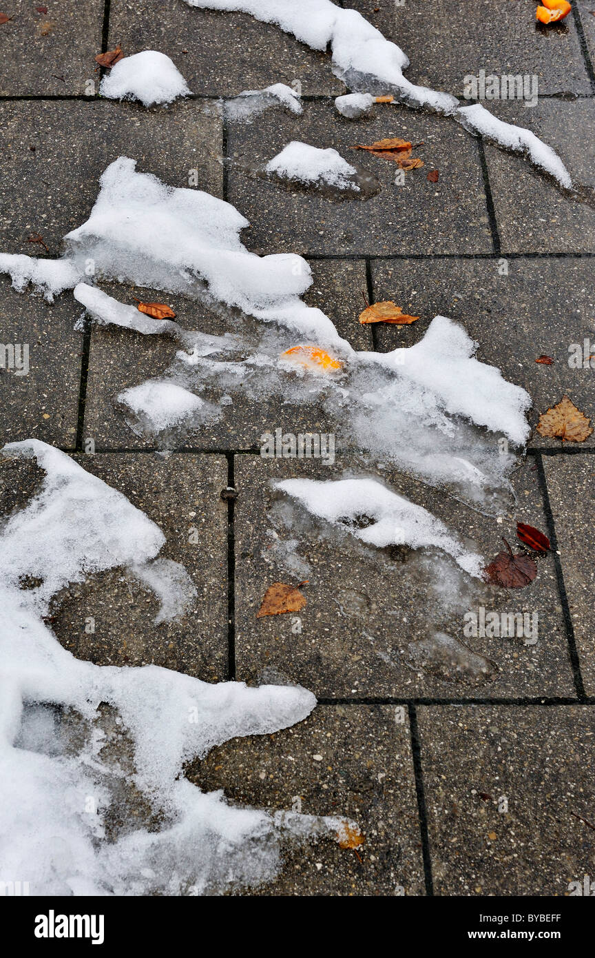 Patches of snow with autumn leaves, Germany, Europe Stock Photo