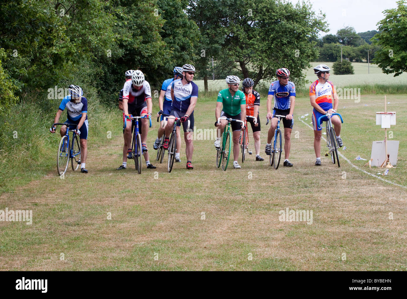 Cyclists line up at the start of a grass track race in rural Suffolk. Stock Photo