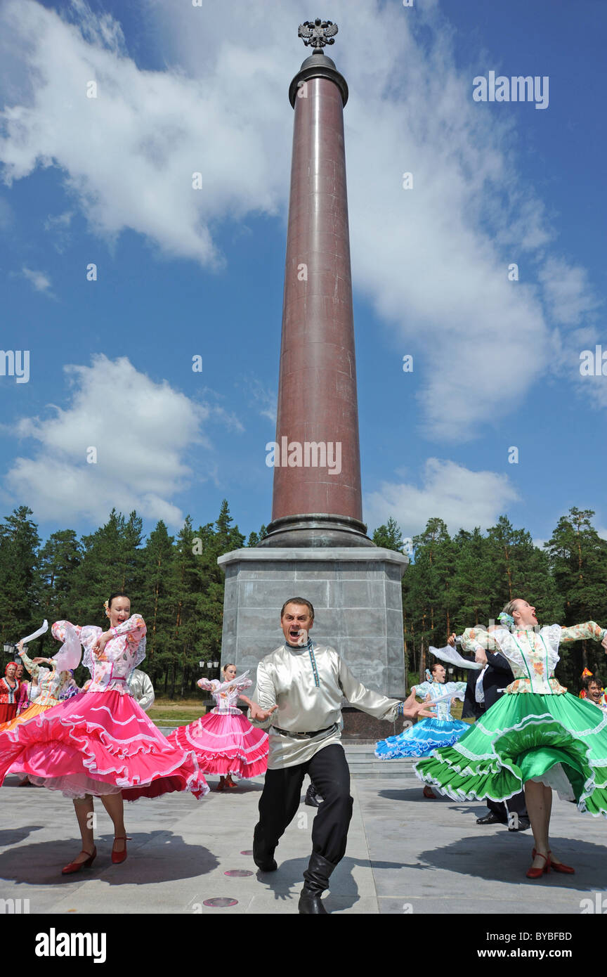 Obelisk marking the border between Europe and Asia, performance of a Russian dance company, bread as a symbol of hospitality Stock Photo
