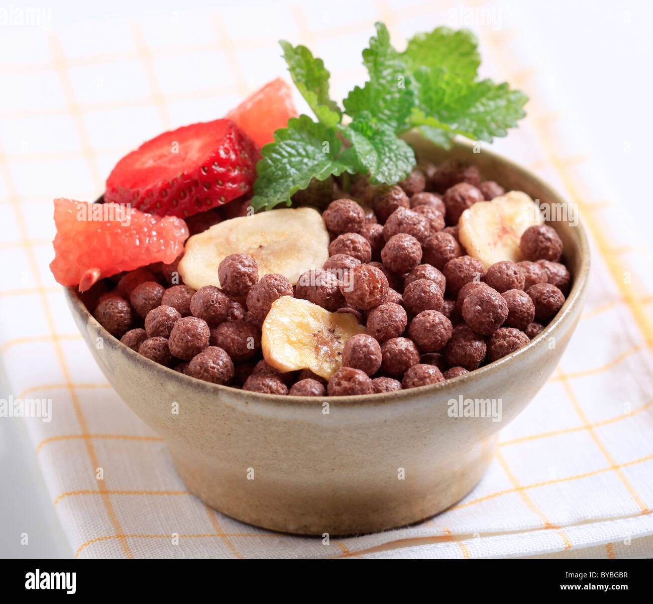 Bowl of chocolate breakfast cereal and fruit Stock Photo