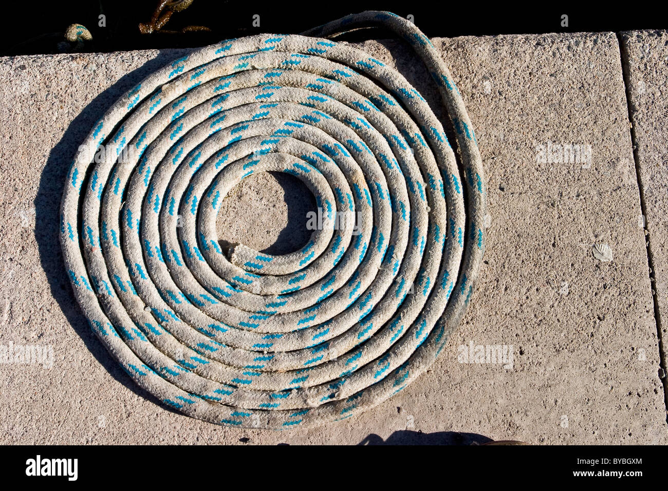 Coiled rope on quayside Stock Photo - Alamy