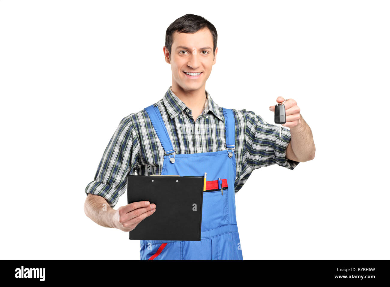 Mechanic in uniform holding a car key and clipboard Stock Photo - Alamy