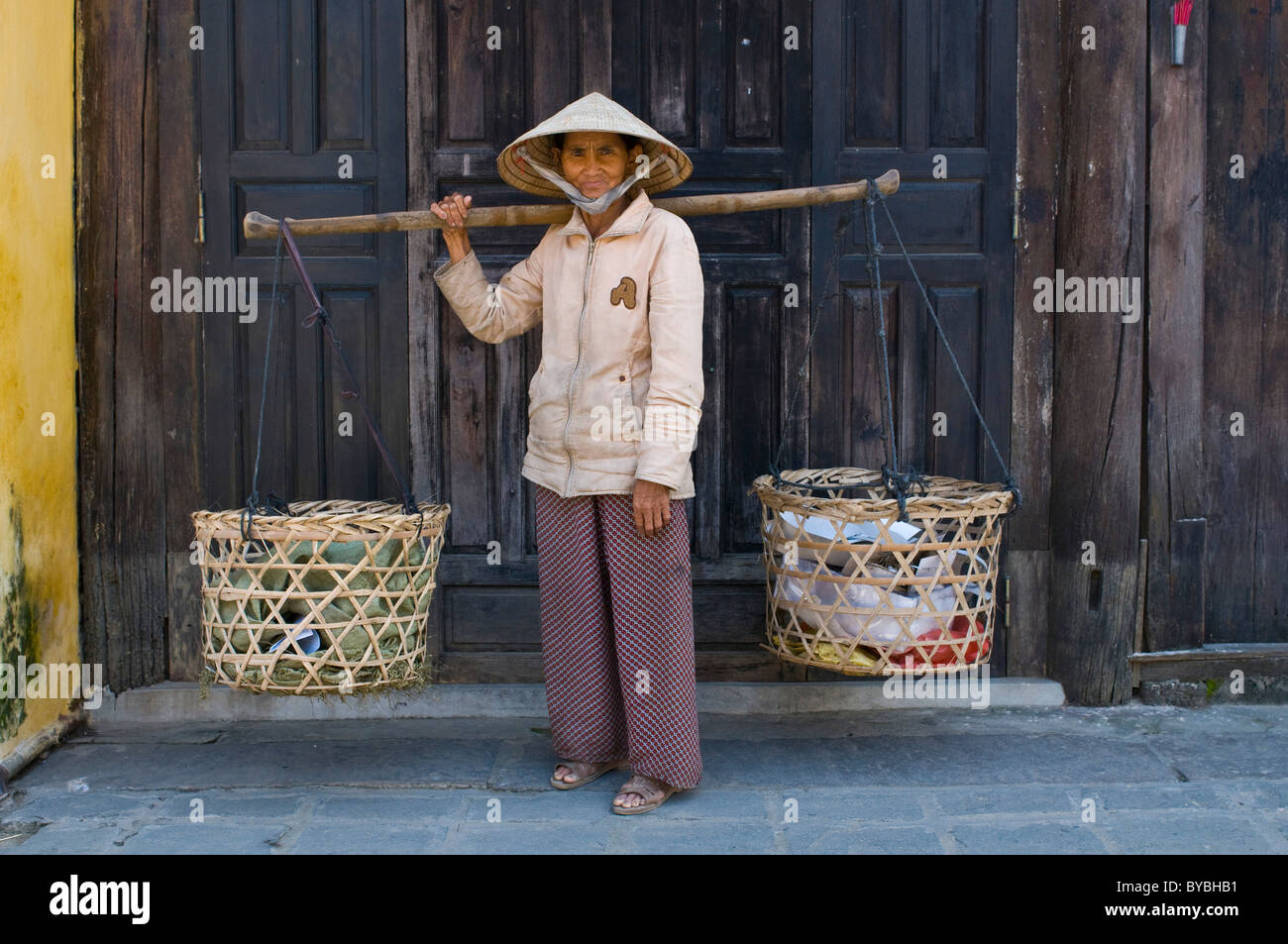 Man is carrying commodity, Hoi An, Vietnam, Asia Stock Photo