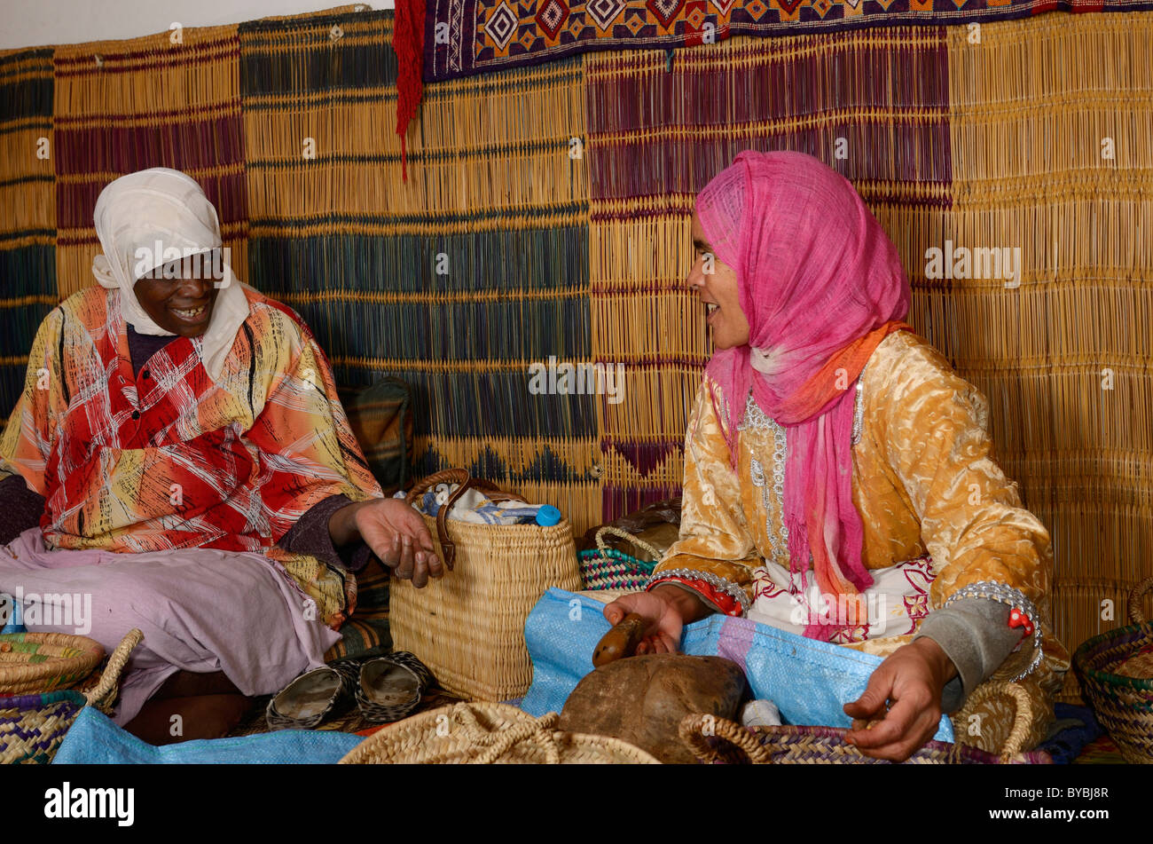 Two Moroccan women at the Afous Argane womens cooperative cracking Argan kernels Morocco Stock Photo